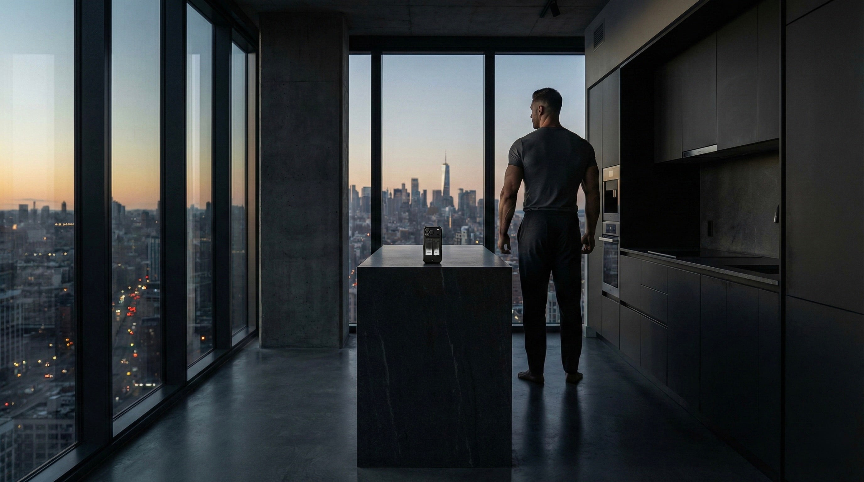 a man seen from the back, in his apartment with a view on NYC skyline. He is admiring the morning view. On the kitchen counter, an iPhone standing with an aesmor case